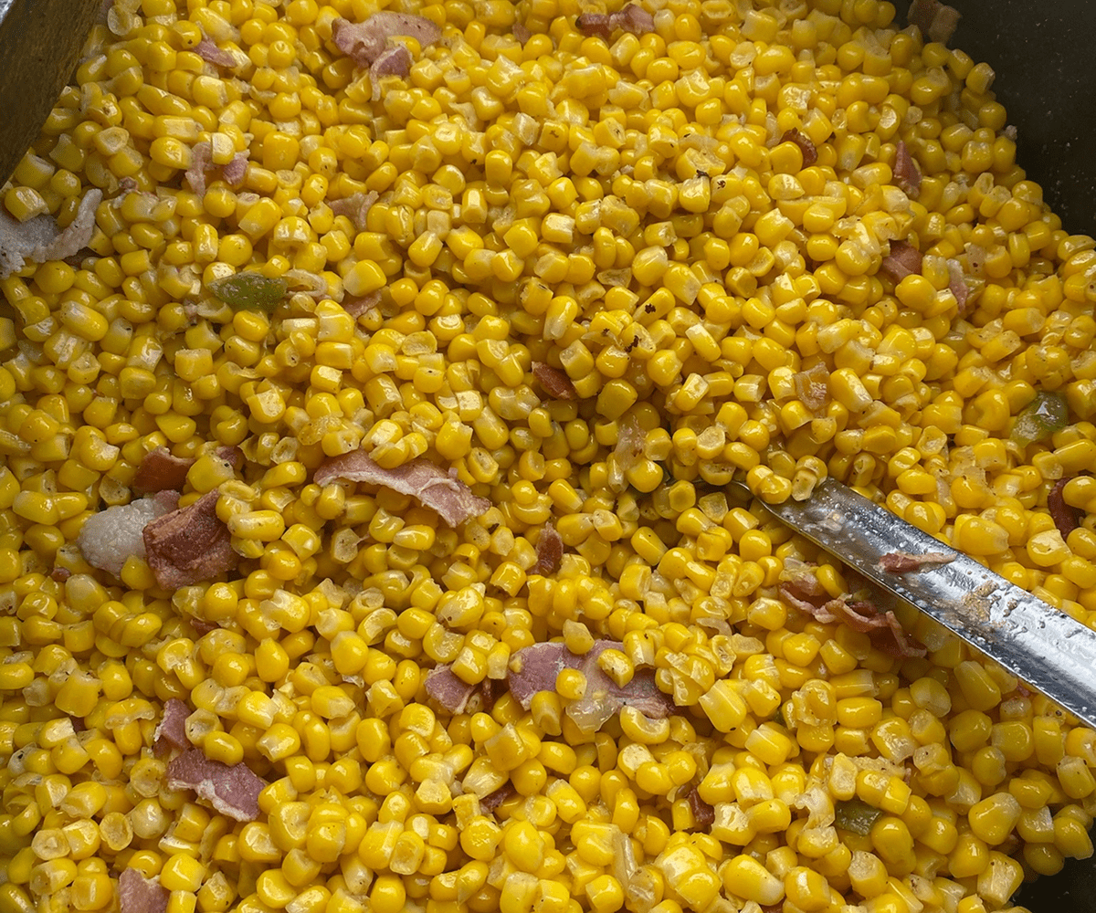 Yellow corn and bacon in a pan